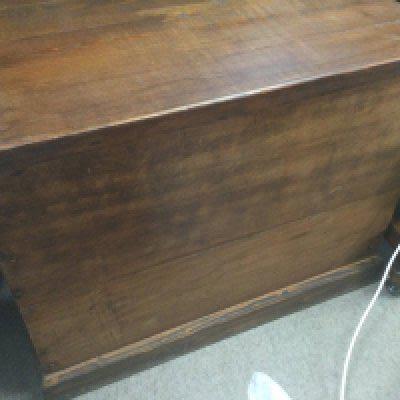 A pine trunk with hinge lid and plinth base .
