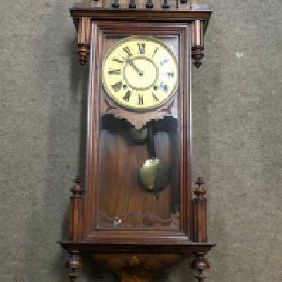 A Continental wall clock with inlaid and carved wood design. Dimensions approximately 16x38x100cm