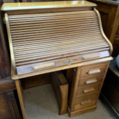 A small oak tambour topped desk. 92cm x 117cm. X 68cm