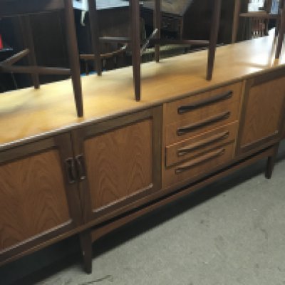 A G plan dining table together with sideboard and five chairs .