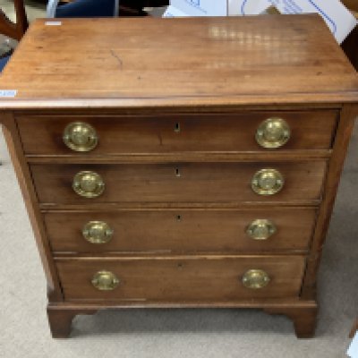 A small George III walnut 4 drawer chest with circular brass French each design handles.