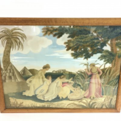 An oak framed tapestry of a middle eastern scene depicting ladies admiring a young child, with a watercolour sky background. Dimensions 60x51cm. This lot cannot be posted