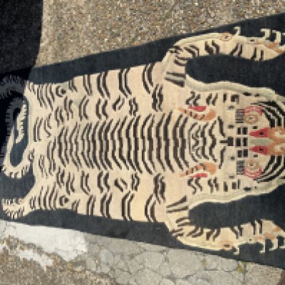 A vintage Tibetan lion dog rug.