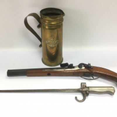 A brass trench art jug, reproduction pistol and a bayonet (3). Shipping category D.