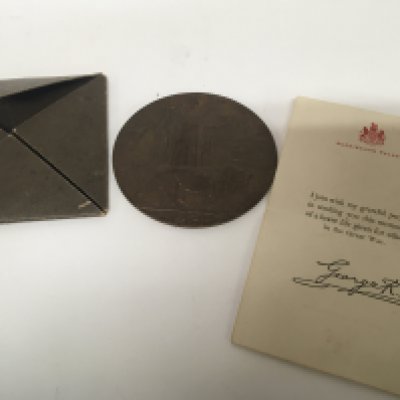 A First World War Memorial Plaque retrospectively awarded to the family of Thomas Henry Ward Killed in action with accompanying letter from the King. And outer cover.