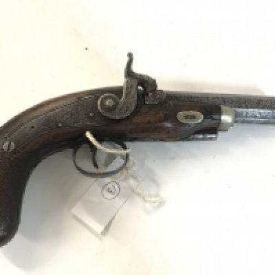 A Mortimer percussion pistol with an ornate handle.
