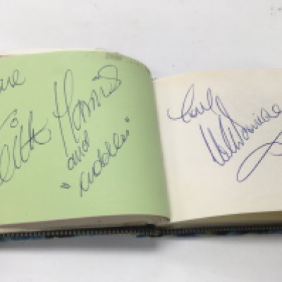 A book of autographs including autographs from Betty Davis, Cliff richard and more.