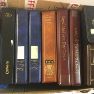 A box containing presentation packs and first day covers.