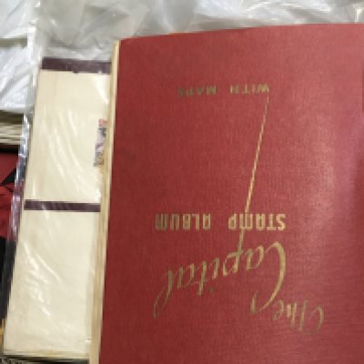 A box of loose stamps, including a world stamp album. Postage category C