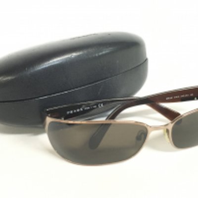 A pair of cased Prada SPR 53F sunglasses. Postage category A
