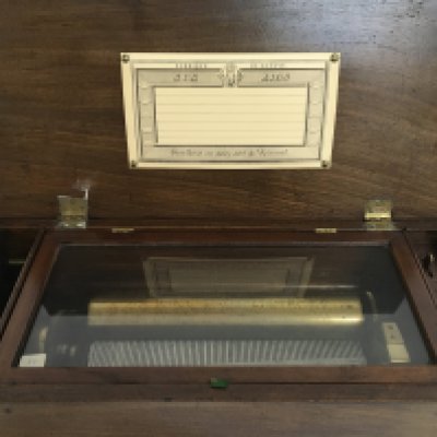 A early 20th century French Cylinder music box with six airs. Dimensions 44x14x20cm. This lot cannot be posted