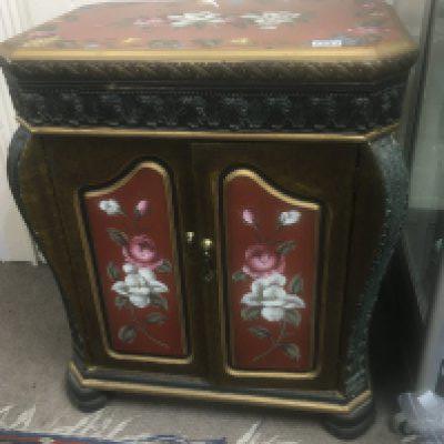 A hand painted cabinet the top with flowers and foliage above two doors the frieze moulding in the form of stylised acanthus leaves. 75cm high x 45cm wide 64cm wide nice condition.- NO RESERVE