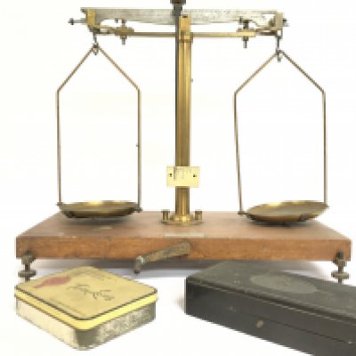 Brass and wood beam balance scales with weights. Postage category C