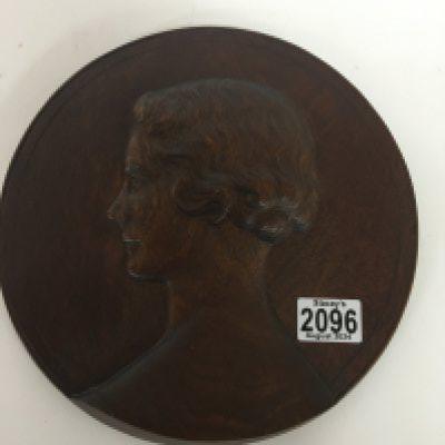 A 20th century carved wood plaque depicting a side profile of a lady possibly 1920s no damage diameter 27cm.