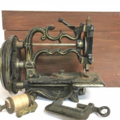 A cased antique sewing machine. Postage category C