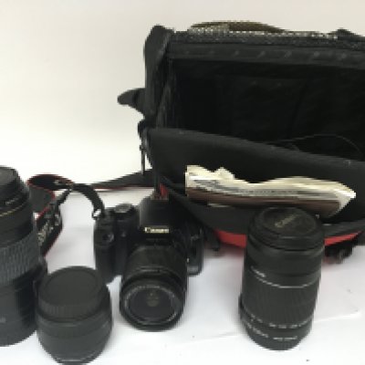 A Canon EOS 450D camera with two extra Canon lenses