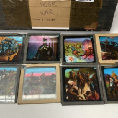4 boxes of vintage glass slides including a collection of Boar War coloured slides, Stanley across Africa, varied collection of storyboard slides. (D)