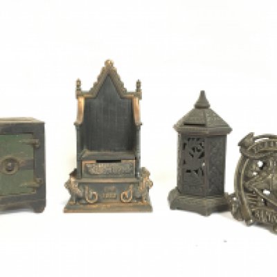 A collection of vintage cast iron money boxes including a Tally Ho Bank horse shoe, Coronation throne by Harper etc. Postage category C