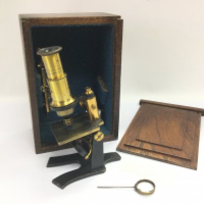 A small boxed brass microscope. Shipping category D.