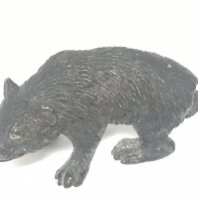 A small late 19th century bronze in the form of a bear. Length 6cm