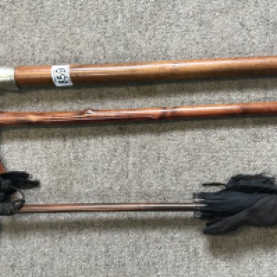 A vintage parasol and 2 walking sticks.