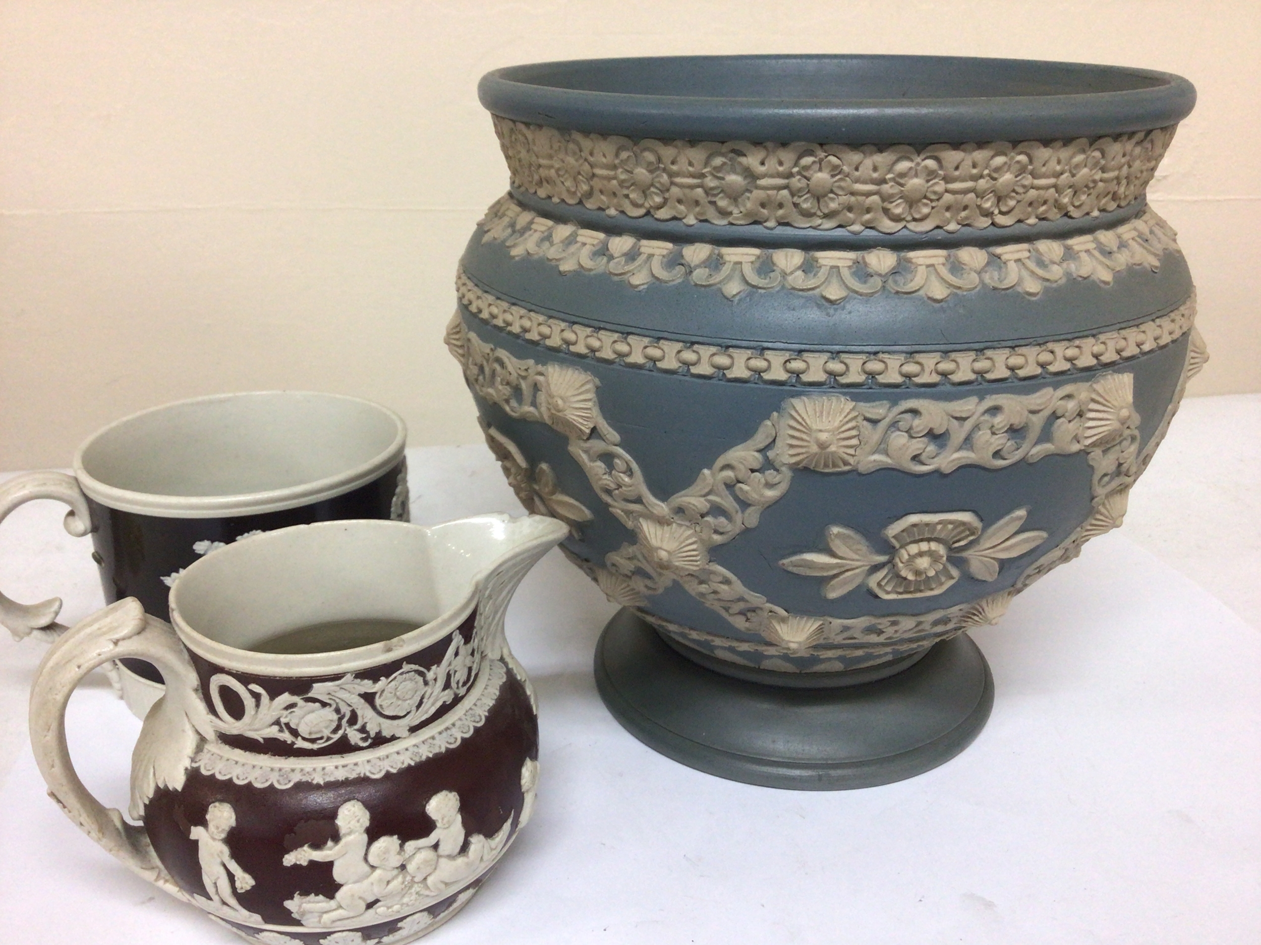 A Victorian Lambeth Doulton jardiniere with raised decoration on a pale blue ground a 19th century Spode jug and conforming cup NO RESERVE
