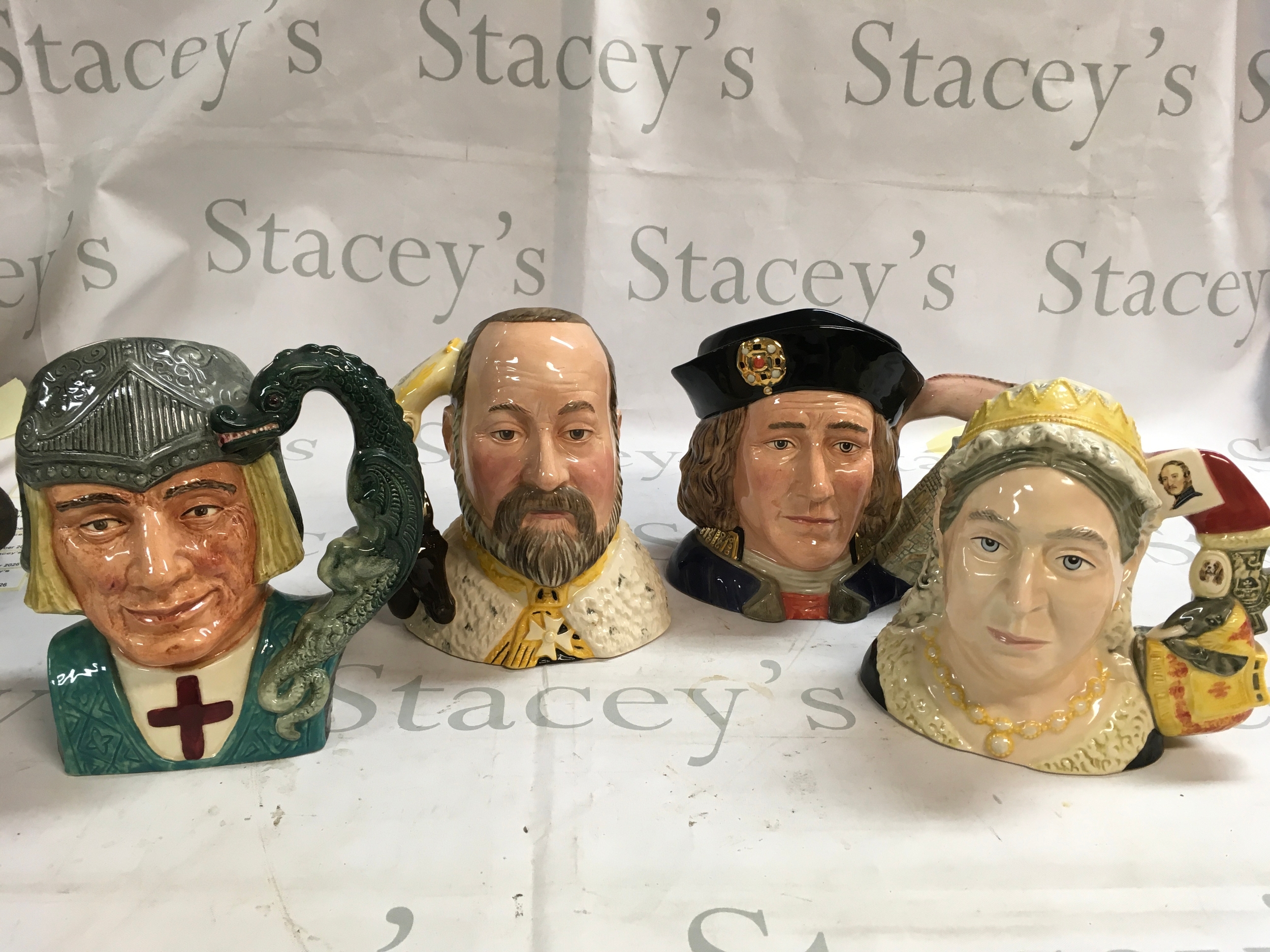 A collection of four Doulton Character jugs featuring monarchs. Richard III, St George, Queen Victoria, and Richard VII
