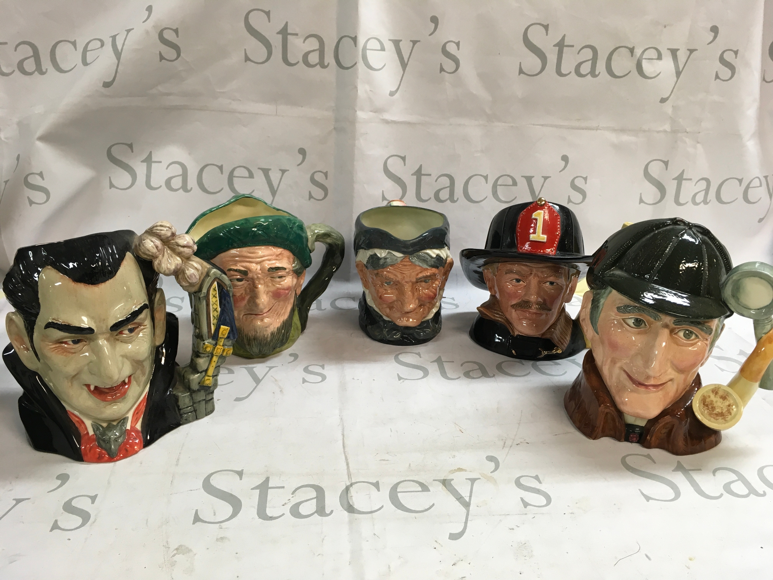 A collection of 5 Character jugs including Count Dracula, The Sleuth  , The fireman, granny, and Auld Mac.