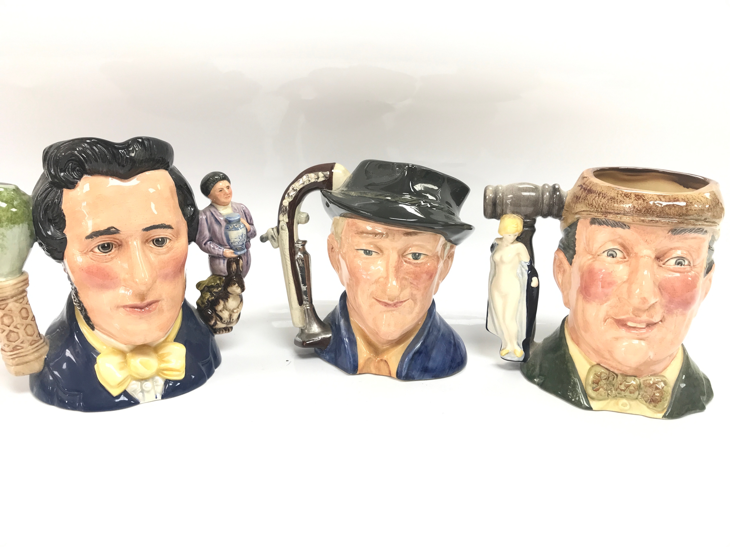 3 Royal Doulton character jugs  .Sir Henry Doulton D 7054 .The antique dealer D 6807 .The Auctioneer D 6838