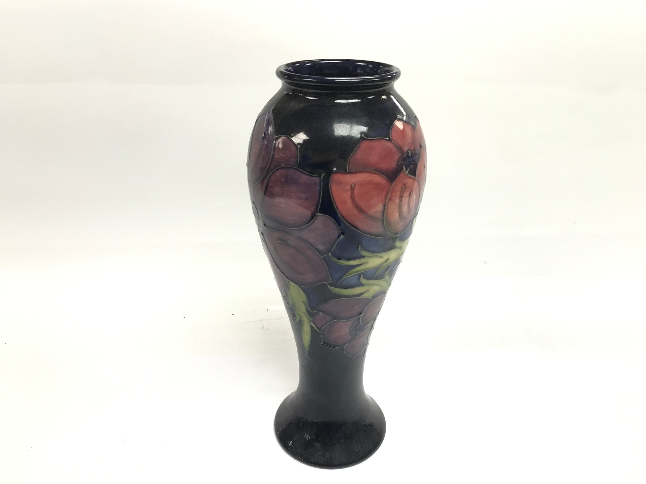 Moorcroft Pottery ceramic vase decorated in the signature tube lined 'Anemone' pattern 29cm tall