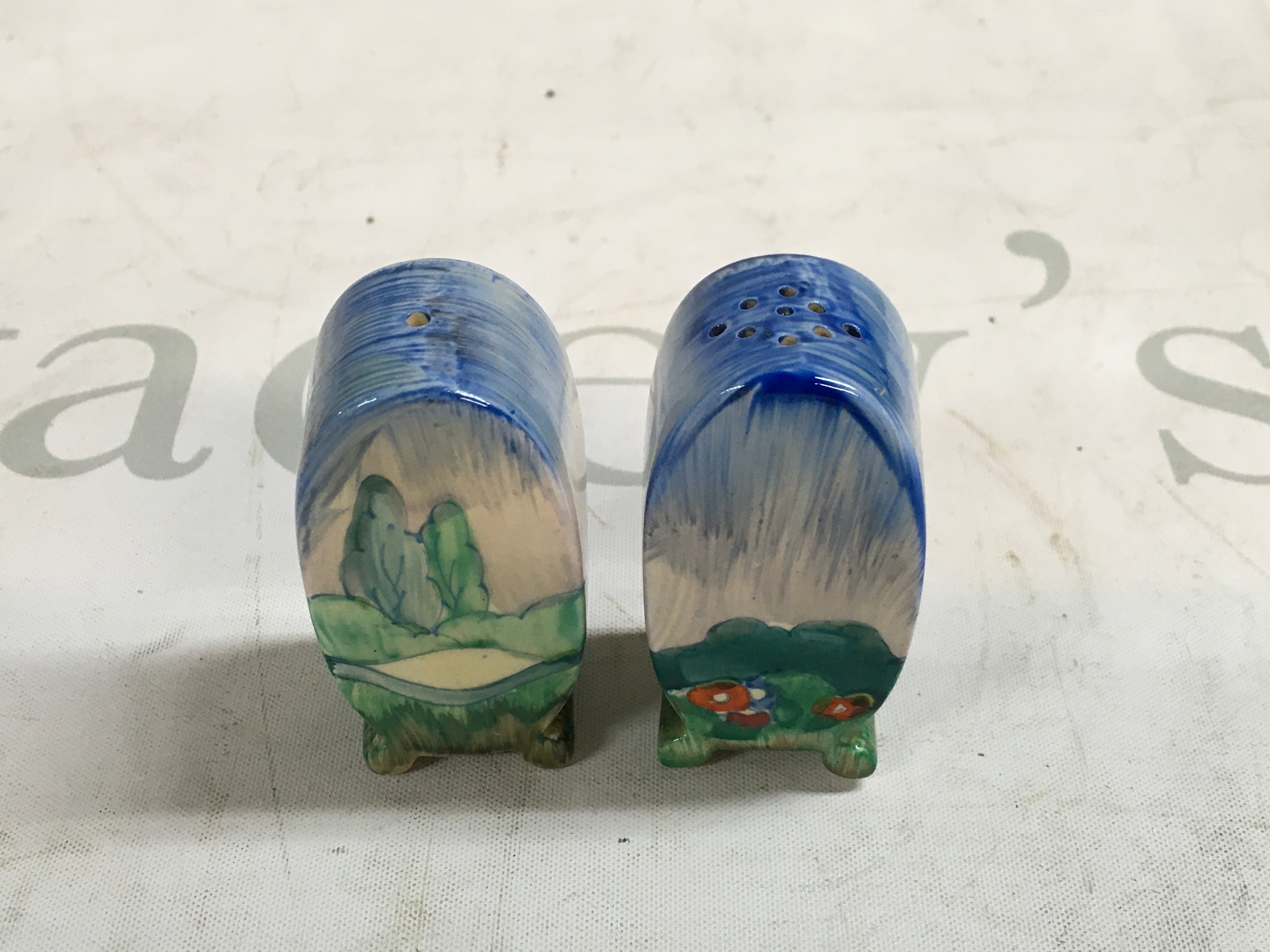 A pair of hand painted Clarice Cliff salt and pepper shakers 