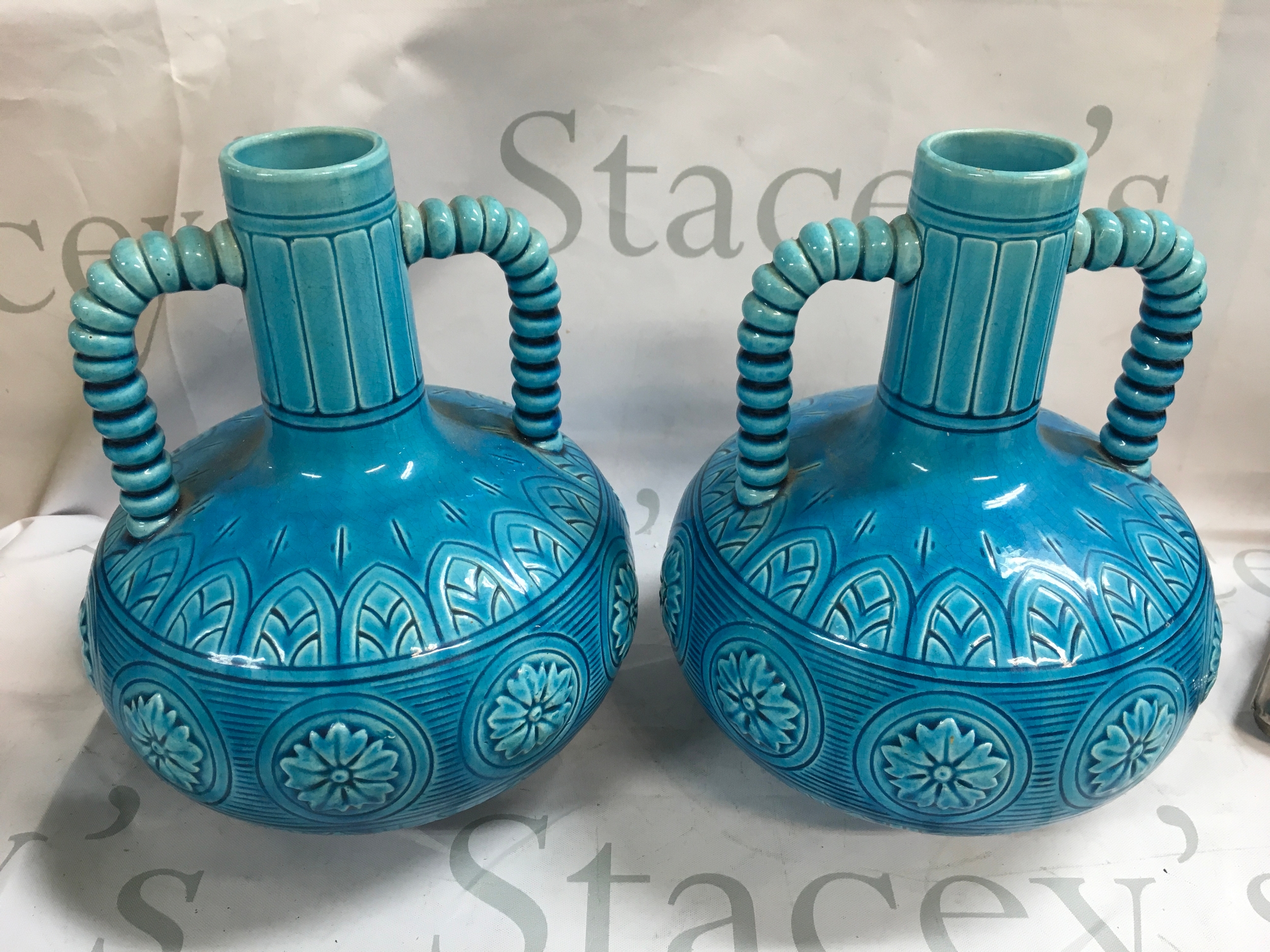 A pair of blue Victorian vases and an Art Deco green glazed ceramic sculpture featuring a lion and a lioness 