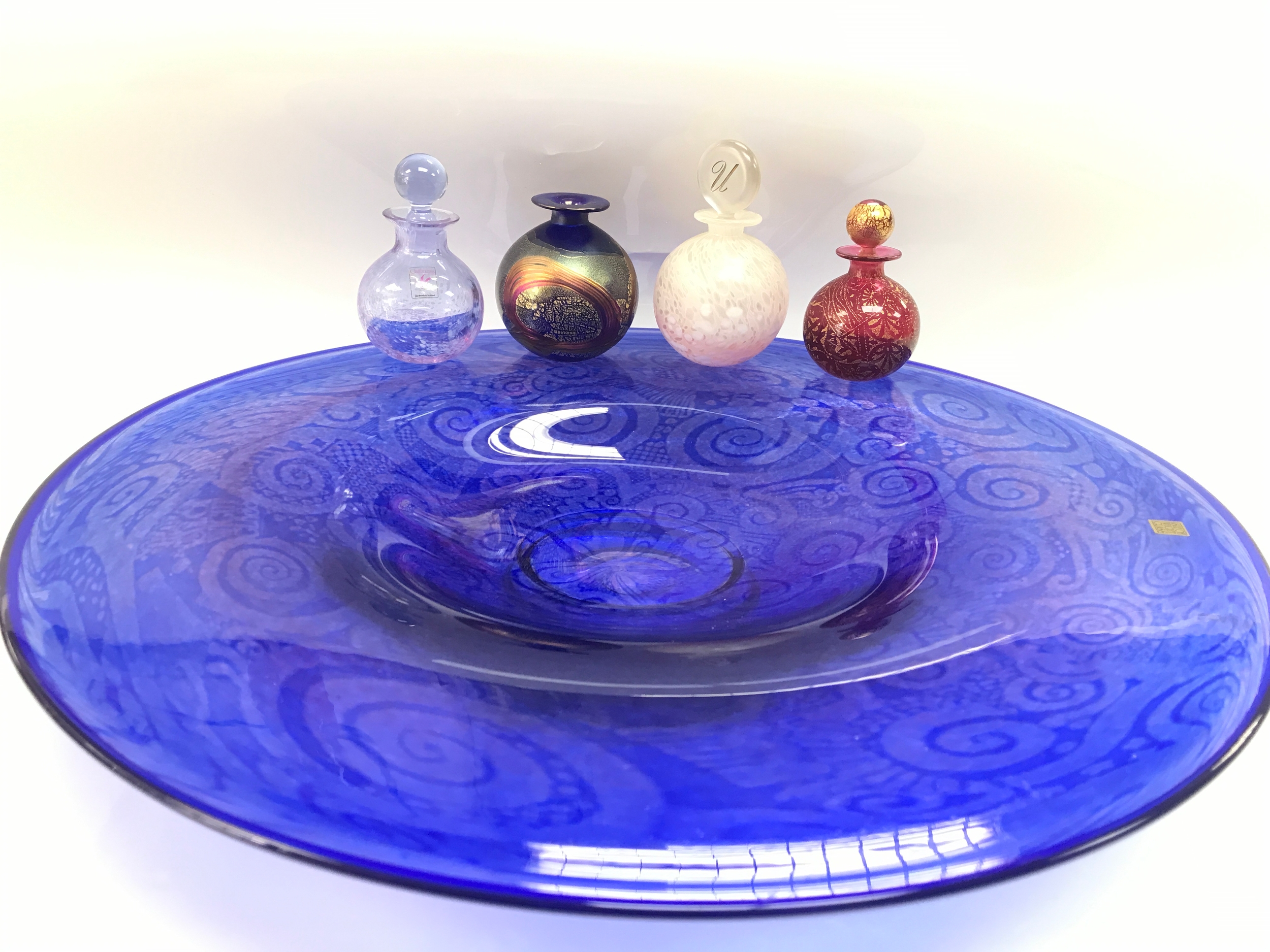 Isle of white glass dish and three valuable perfume bottles