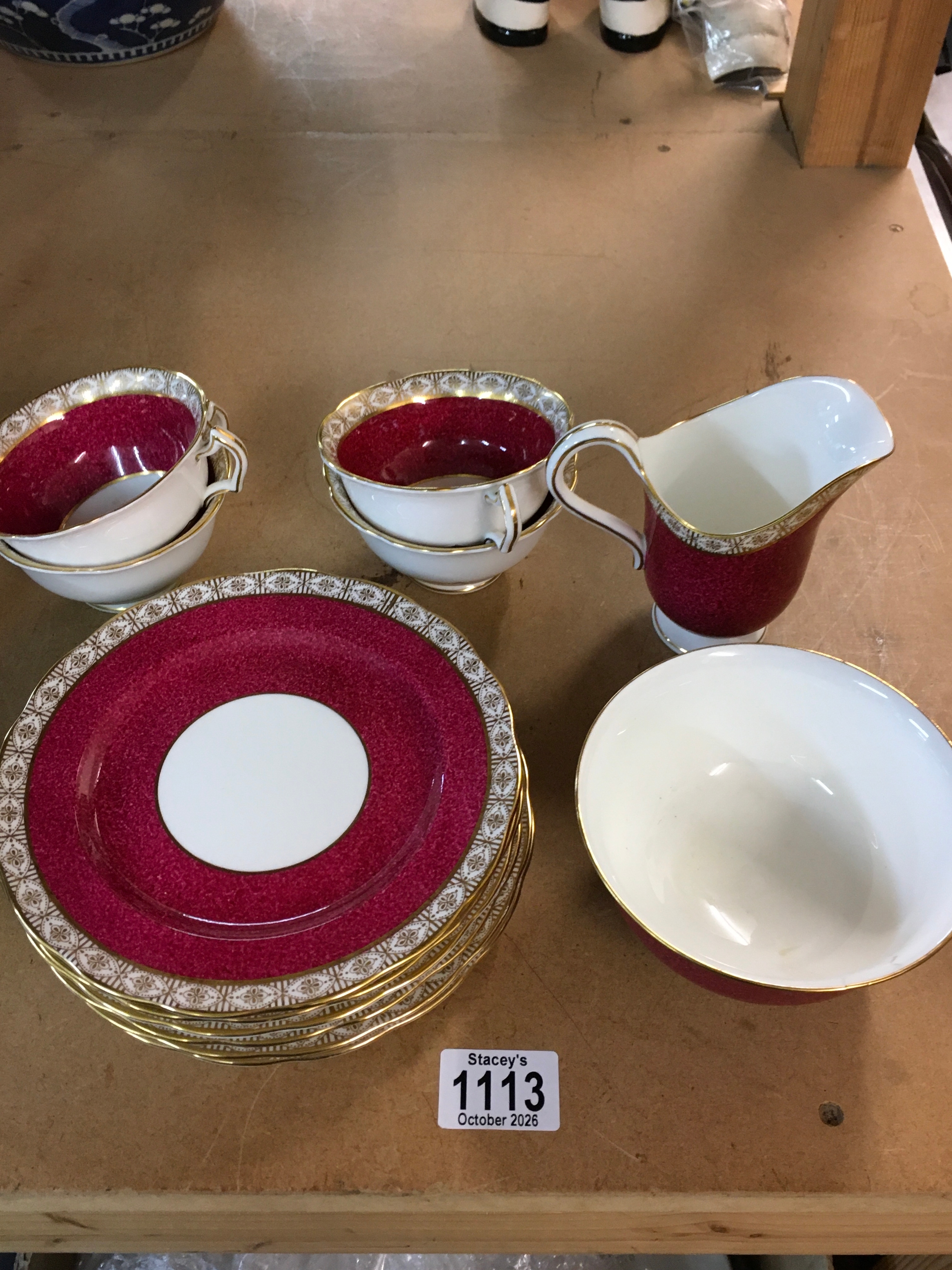 A small collection of George Jones red glazed tableware 