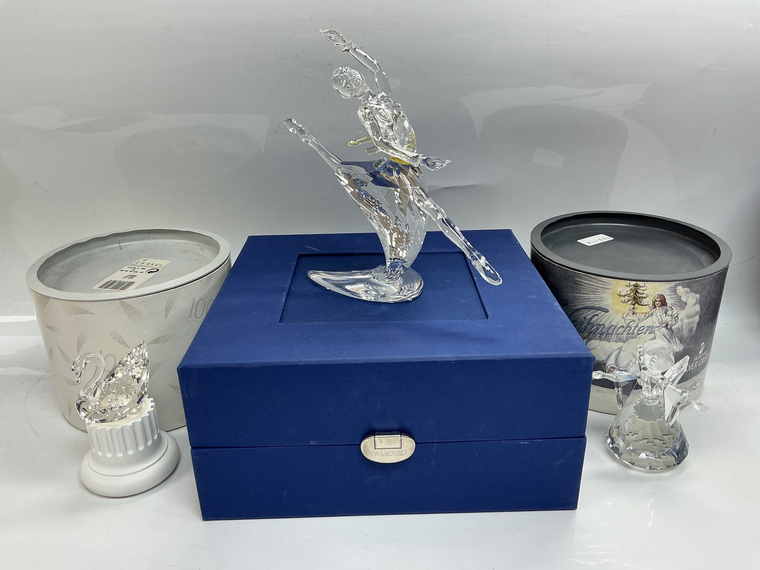 Three boxed Swarovski figures comprising a ballerina, angel and Swarovski swan.