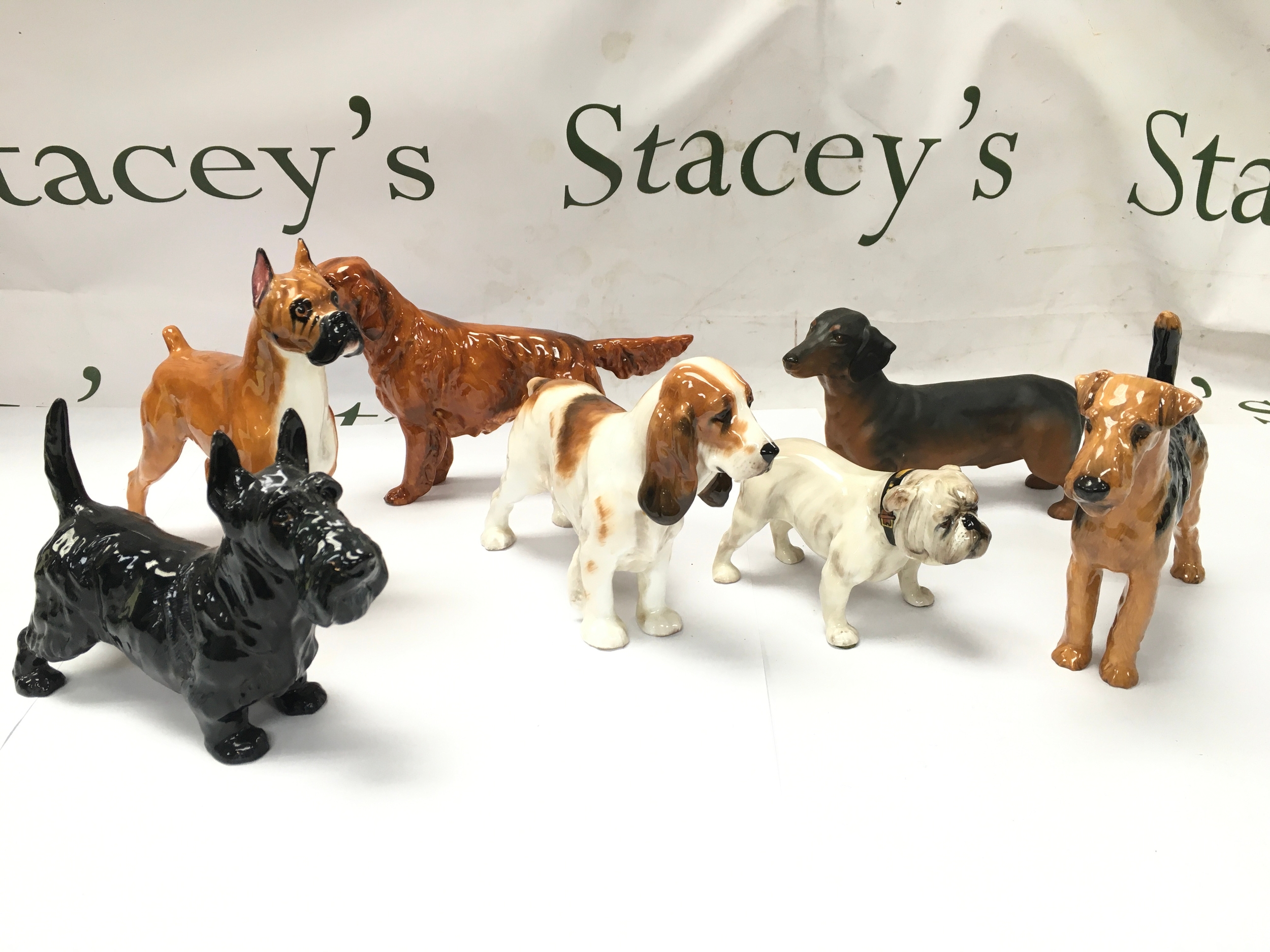 vintage ceramic and porcelain dog figurines from Beswick and Royal Doulton include Royal Doulton Irish Red Setter porcelain figurine modeled after Champion Pat O'Moy. all appear in excellent condition with no obvious signs of damage or repair.