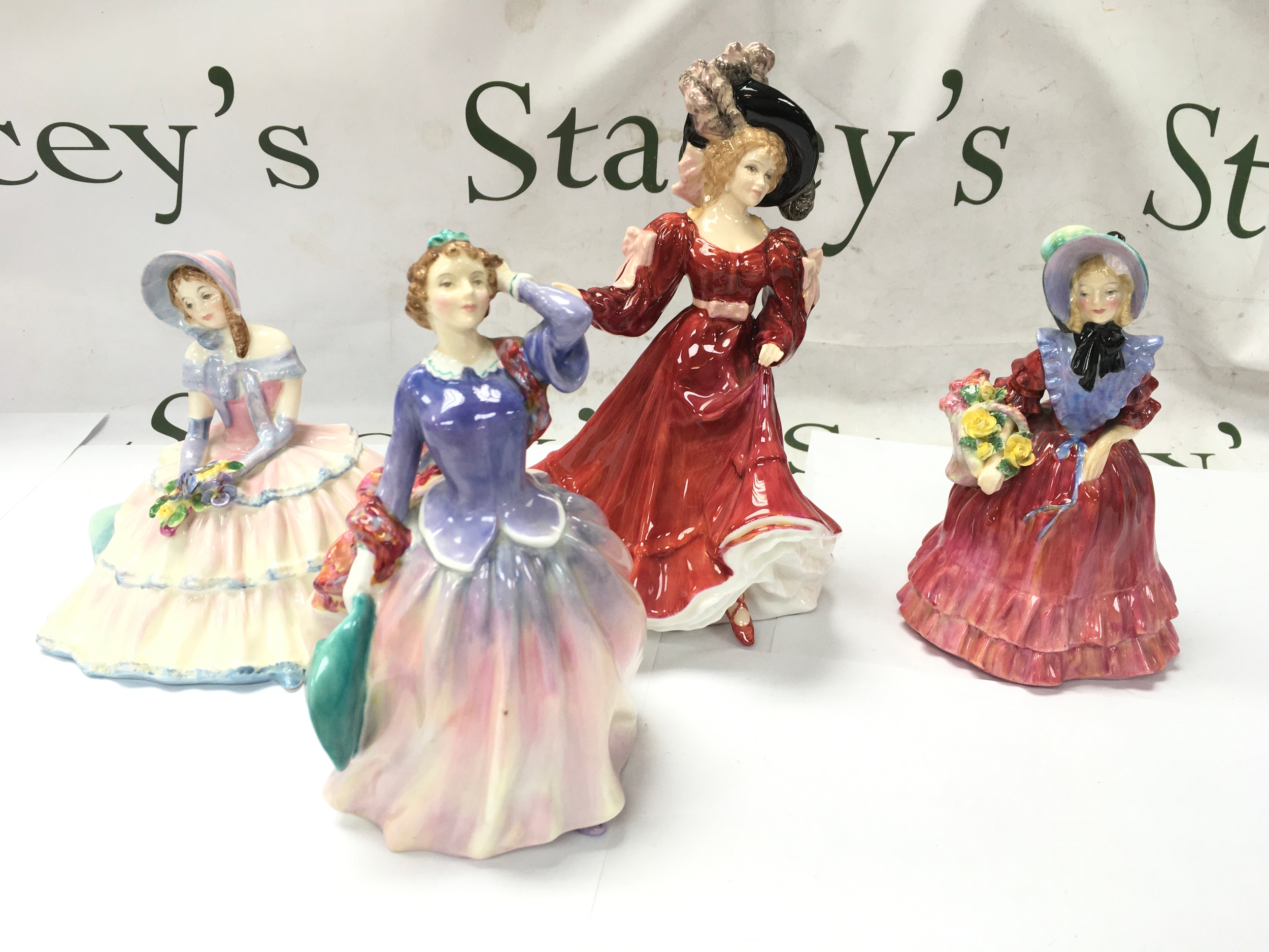 Four Royal Doulton figurines including Blithe Morning etc. all in good condition with no obvious signs of damage or repair.