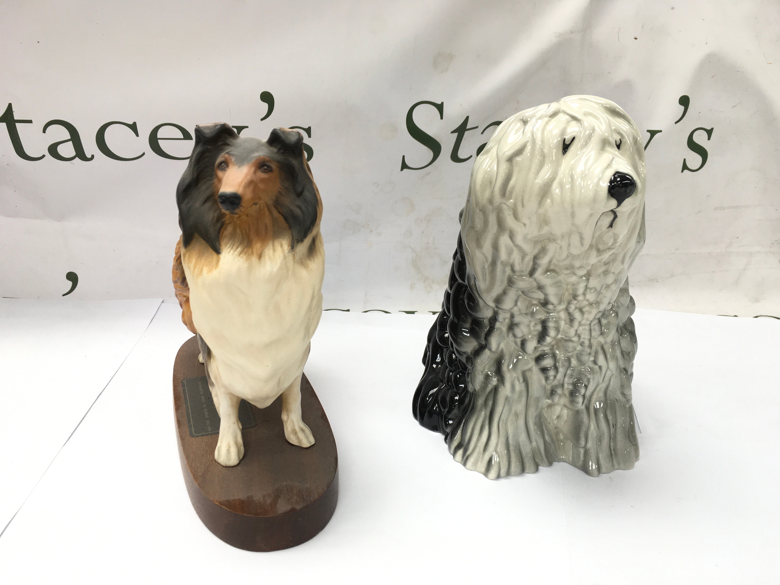 A Beswick Connoisseur series model of a Rough Collie standing on a wooden plinth and an Old English Sheepdog. Good condition no obvious damage 