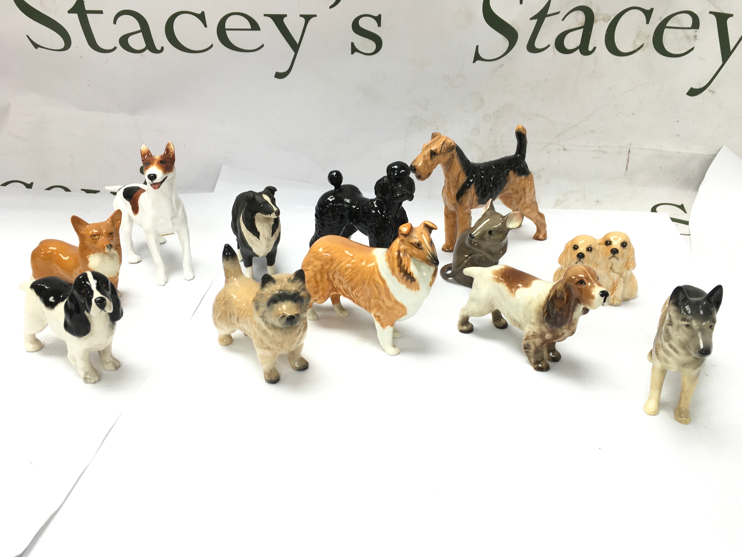 Collect of small cermaic dog figurines including beswick such as Corgis, Poodles, Cocker Spaniels etc