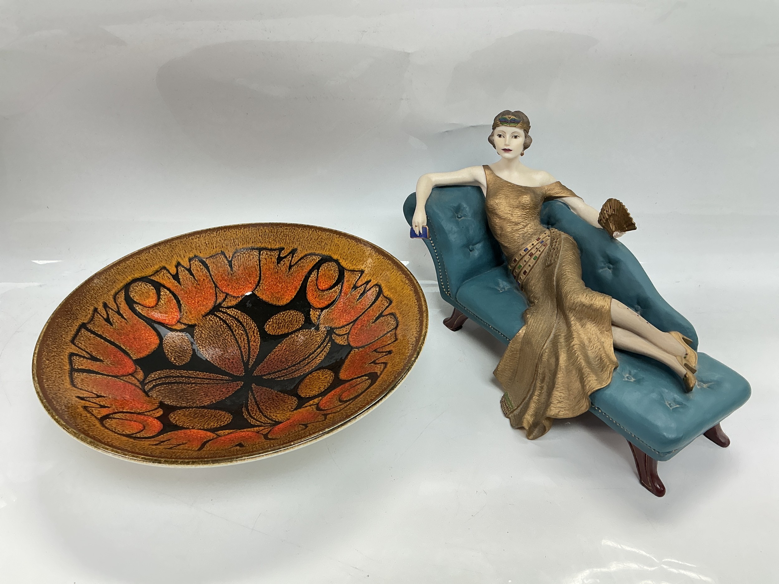 A Poole dish in Aegean pattern, approx diameter 26.5cm and a Wedgwood figure of Penny from The Roaring Twenties range (2).
