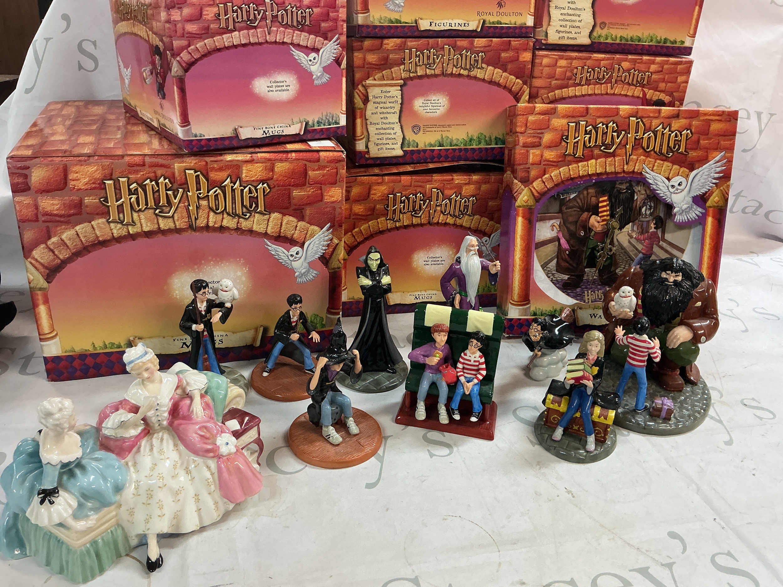 A collection of boxed Harry Potter Royal Doulton figures and a Royal Doulton Love Letter figure group