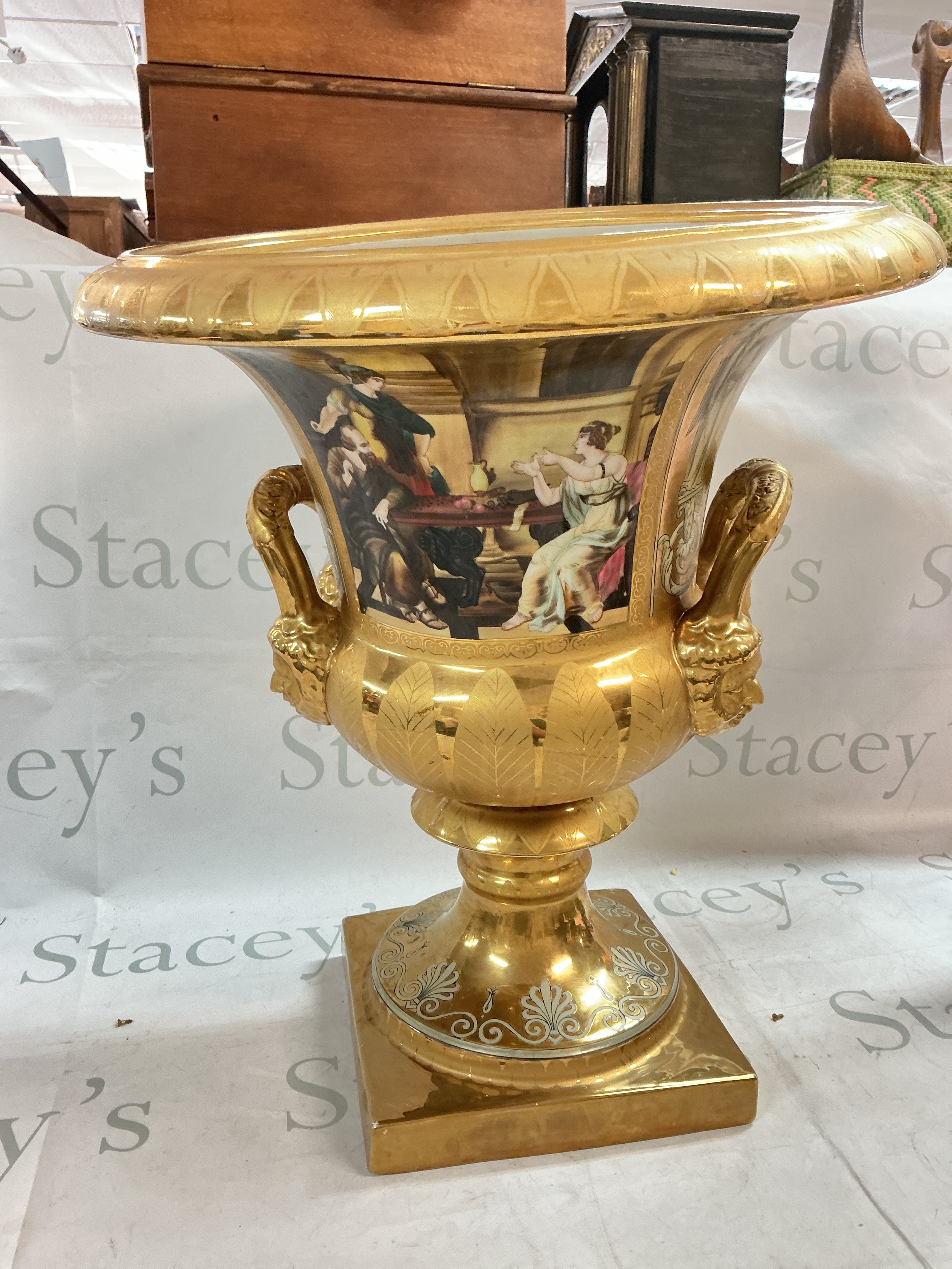 A Vienna style gilt decorated urn with classical panels (50cm tall) and three classic Sevres cobalt blue plates (28cm wide)