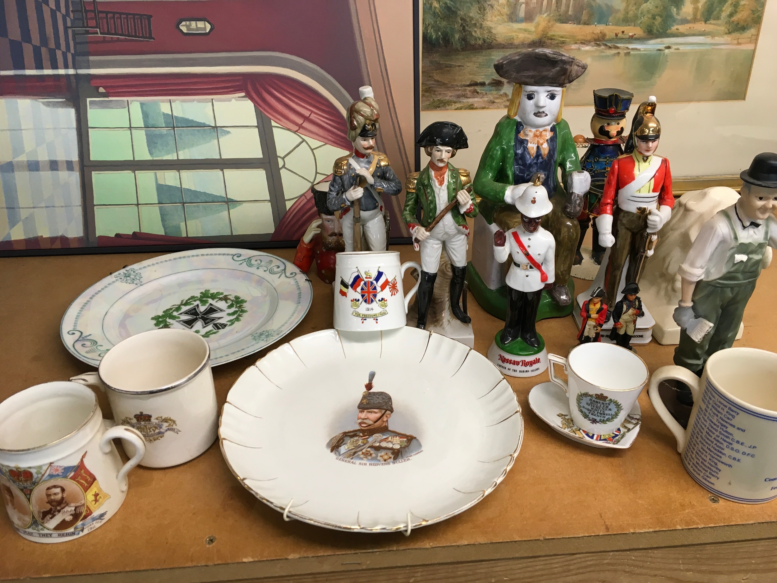 A collection of mixed ceramics including decorative commemorative plates, and various ceramic mugs and cups
