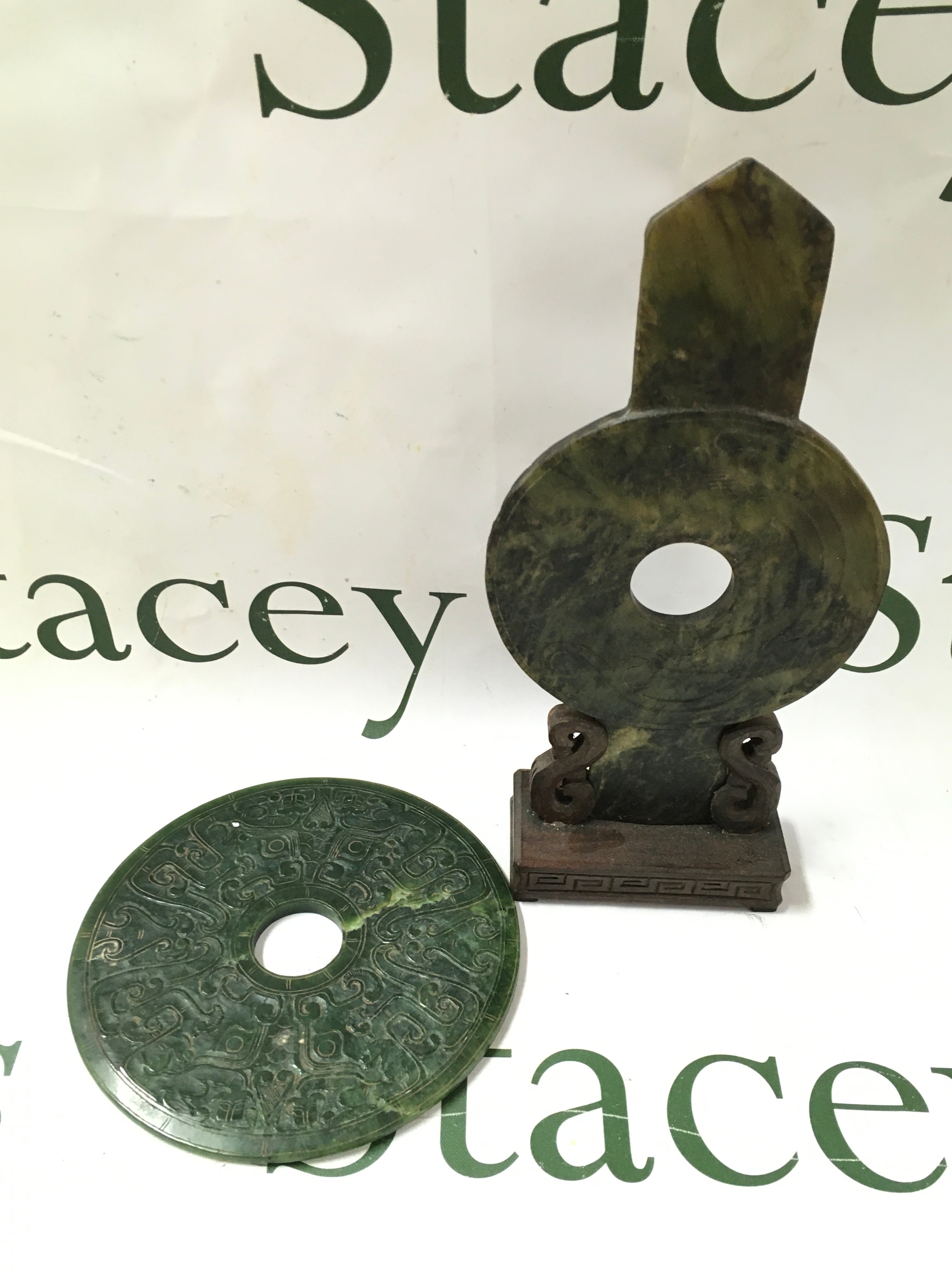 Jade carved spinach nephrite jade bi discs, one mounted on an ornate carved wooden stand. 14cm wide disc. Other 24cm tall
