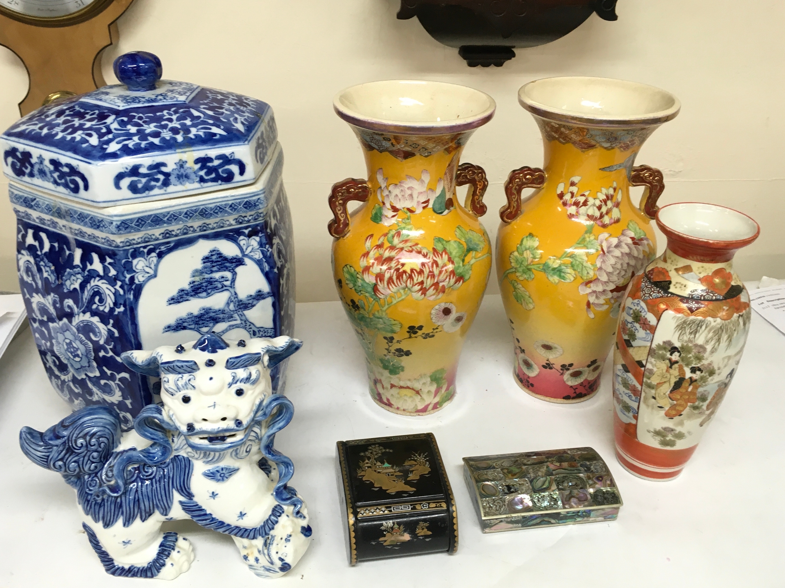 A Collection of oriental ceramics including a Chinese blue and white Fu Dog, Chinese large blue and white hexagonal lidded jar (35cm tall), Pair of Yellow-Ground Vases with floral design, Japanese Kutani vase, Mother of pearl box and a black lacquer box