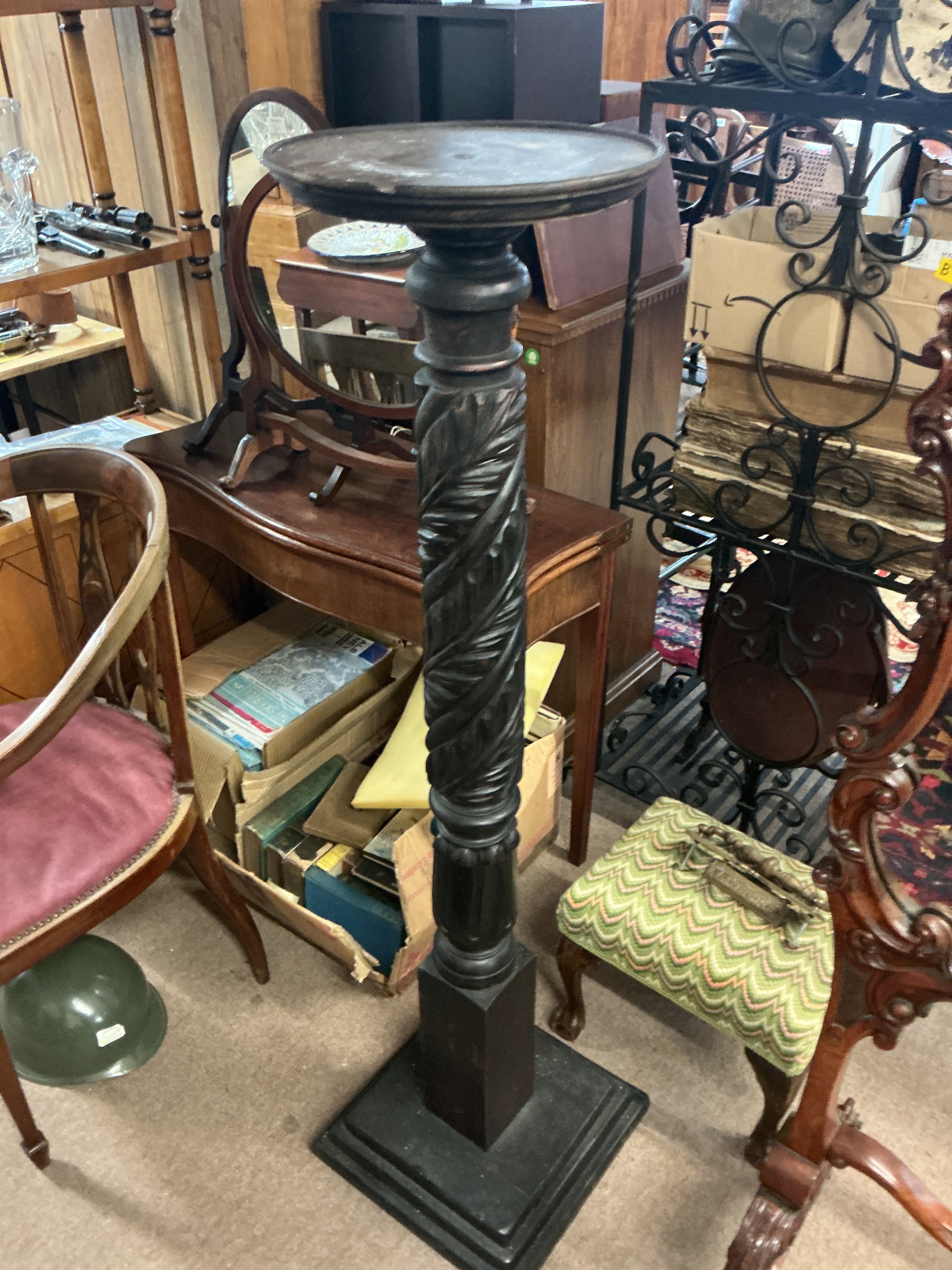 Victorian ebonized torchère with carved design. 135cm tall