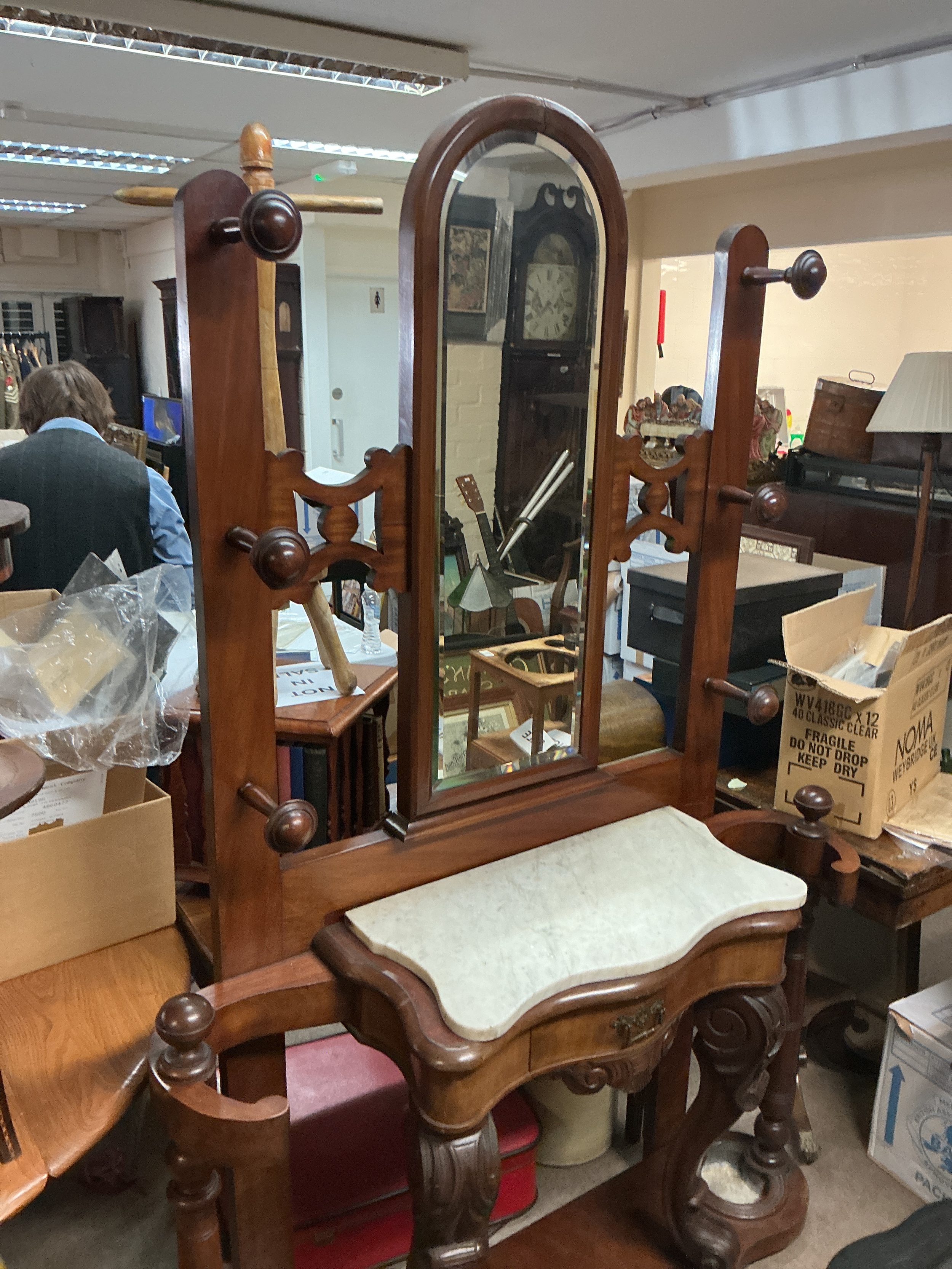 19th-century Victorian mahogany hall stand featuring a central mirror, a white marble shelf, a small storage drawer, coat and hat hooks, and umbrella/stick holders at the base.122cm wide 195cm tall 35cm long 