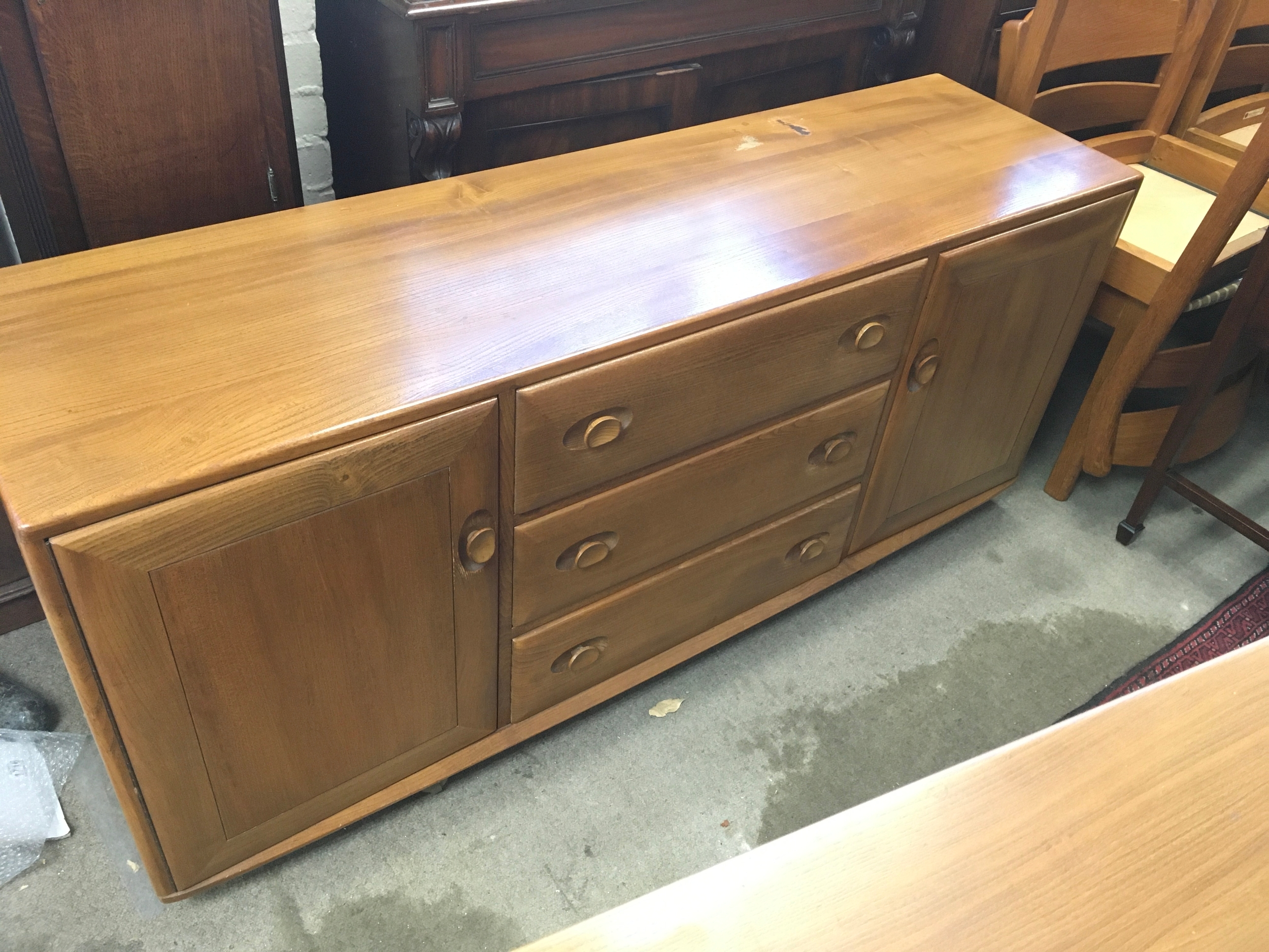 vintage Ercol Windsor Model sideboard in solid elm, with distinctive oval recessed door and drawer pulls 155x45x69cm