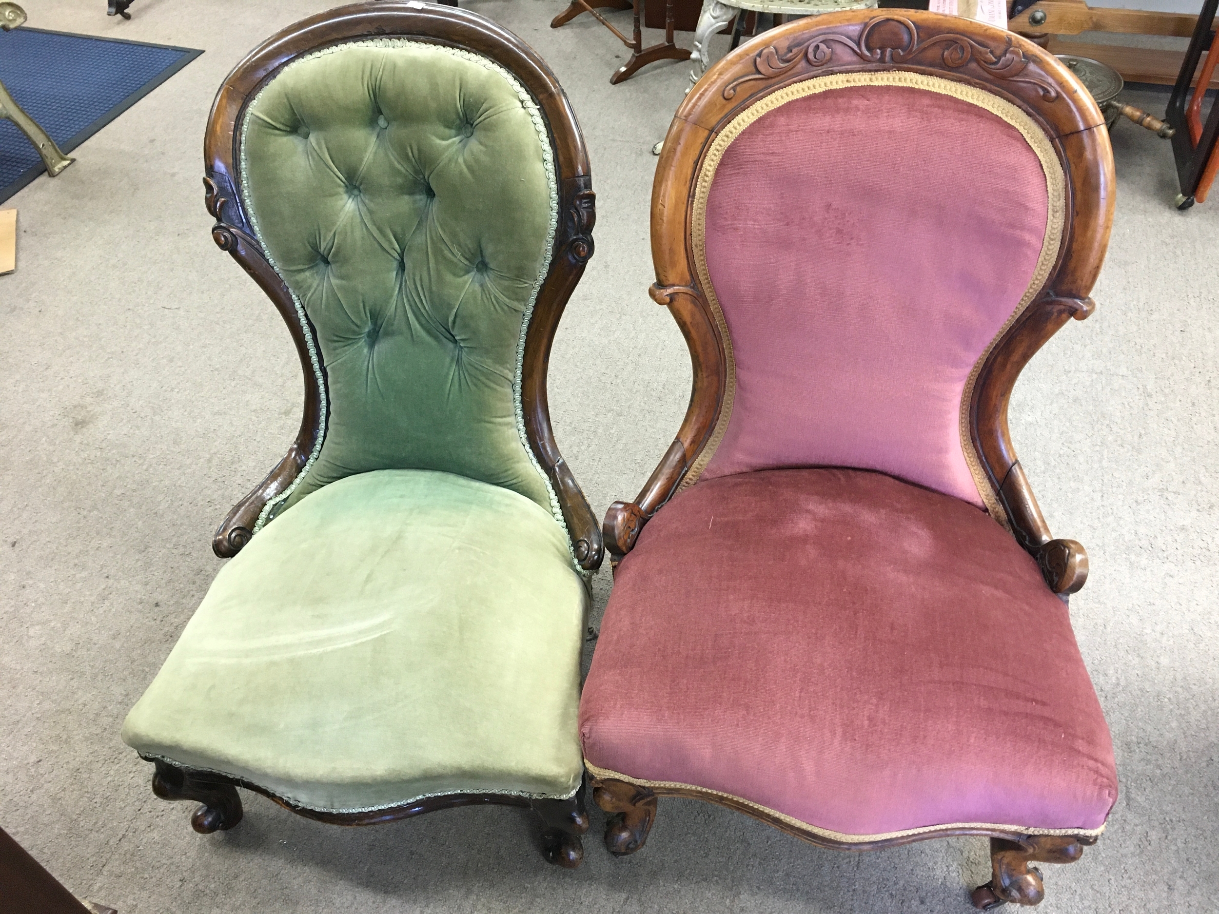 Two antique Victorian low nursing chair. One upholstered in pink velvet and other green button back.