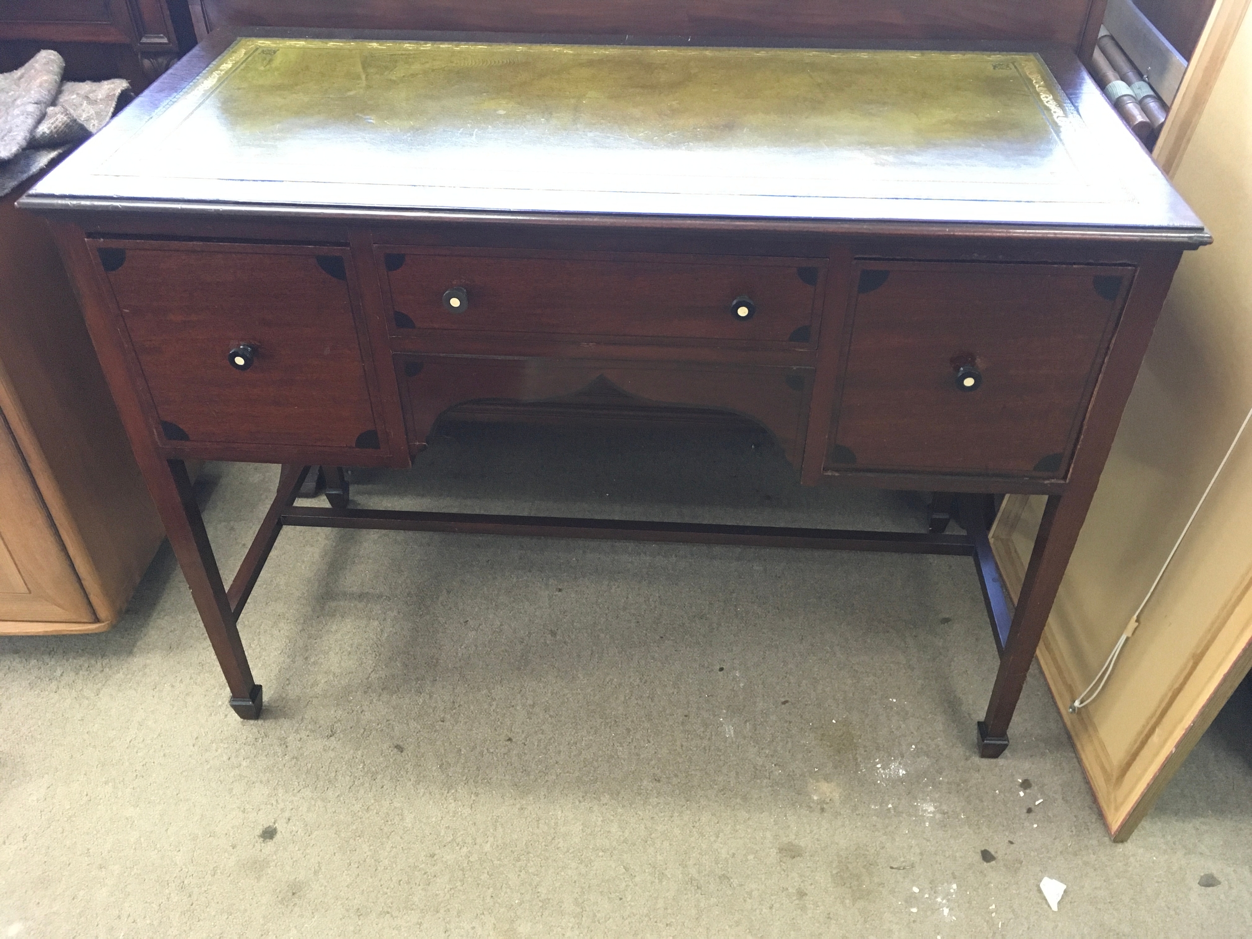 mahogany writing desk with a green, tooled leather writing surface and side cabinet drawers. 97cm by 50cm